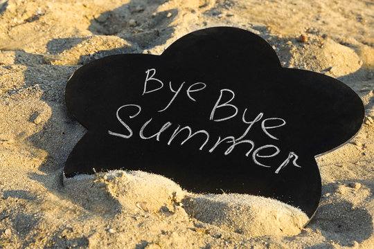 Black board with inscription on sea beach