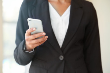 Businesswoman with cellphone in office