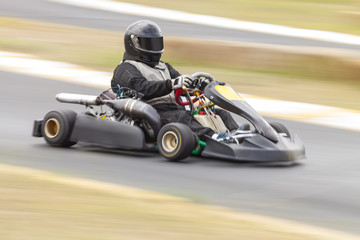 Fototapeta premium Go Kart Racer on Track, Panning Shot to show speed