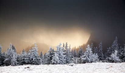amazing winter sunrise through fog in the mountains