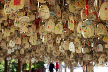 Hanging blessings of Naxi pictograms on wood in the Old Town, Lijiang, Yunnan Province, China