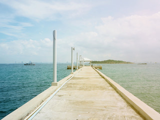 concrete pier on sea/ocean with blue sky background in Thailand.