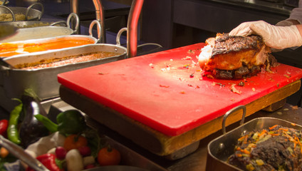Chef Hands cutting Grilled spare beef on a  desk.