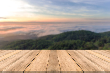 Fototapeta na wymiar Empty wooden table space platform and blurred Sky mountains sunsets Fog background for product display montage