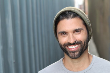Young male with piercing and beanie outdoors