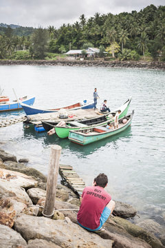 Tourist taking a photo of fishermen on Pulau Weh Island, Aceh Province, Sumatra, Indonesia