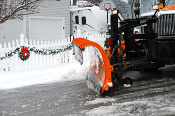 close up on snowplow removing snow in the street