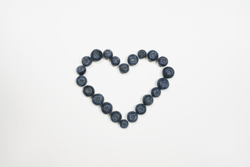 Blueberries in heart shape with white background