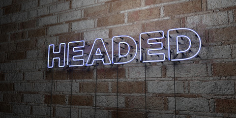HEADED - Glowing Neon Sign on stonework wall - 3D rendered royalty free stock illustration.  Can be used for online banner ads and direct mailers..