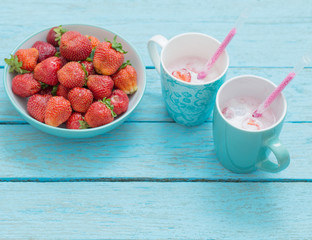 Strawberries with yogurt on a wooden table blue