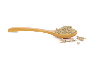 White pepper powder on wooden spoon