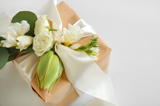Handcrafted gift box with flowers on white background