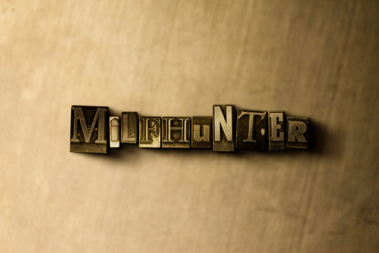 MILFHUNTER - close-up of grungy vintage typeset word on metal backdrop. Royalty free stock illustration.  Can be used for online banner ads and direct mail.