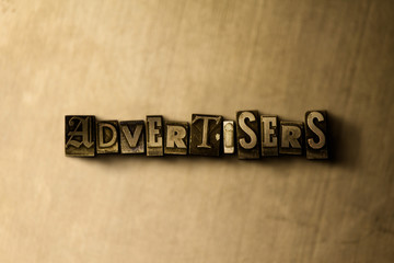 ADVERTISERS - close-up of grungy vintage typeset word on metal backdrop. Royalty free stock illustration.  Can be used for online banner ads and direct mail.