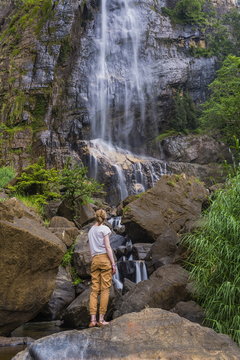 Tourist at Bambarakanda Falls, a waterfall near Haputale, Sri Lanka Hill Country, Nuwara Eliya District, Sri Lanka 