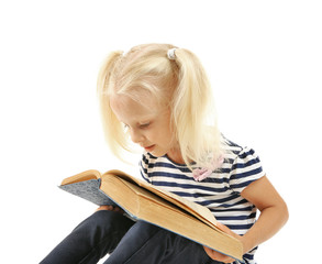 Cute small girl reading book on white background