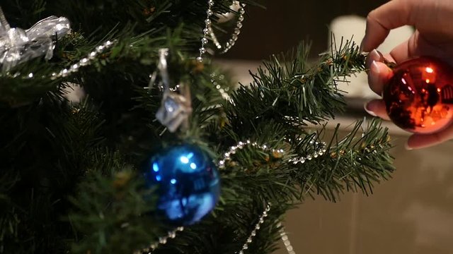 Christmas ball and shoot outweigh him to another branch, slow motion