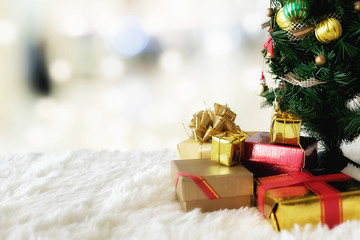 Christmas concept. Christmas decoration, Holiday decorations on snow with blur shopping center background. Soft focus,low light.(selective focus)...