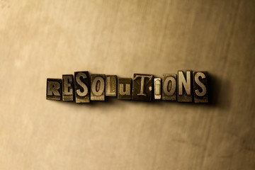 RESOLUTIONS - close-up of grungy vintage typeset word on metal backdrop. Royalty free stock illustration.  Can be used for online banner ads and direct mail.