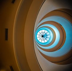 Looking up through the abstract circular floors of a building