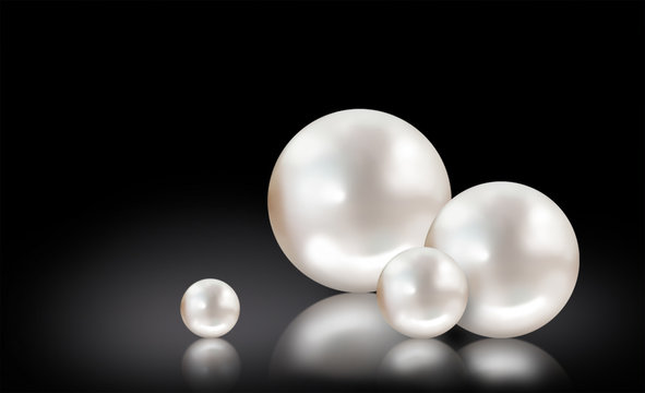 Four white pearls on black background