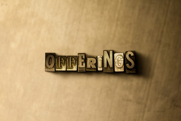 OFFERINGS - close-up of grungy vintage typeset word on metal backdrop. Royalty free stock illustration.  Can be used for online banner ads and direct mail.