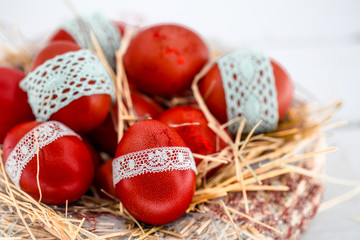 Red Easter eggs in a nest of hay