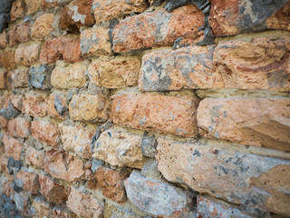 Close up on an old brick wall texture, focus on the middle of the wall. Background of the brickwall pattern close up.