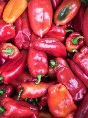 Background of a stacked red peppers. Red peppers pattern close up.