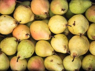 Background of fresh pears close up. Fresh pears pattern on sale at the market.