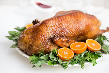 Roasted  duck in honey glaze with spicy herbs and tangerines