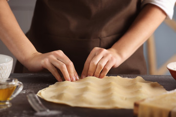 Woman making ravioli on table
