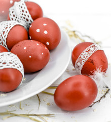 Red Easter eggs on a white plate