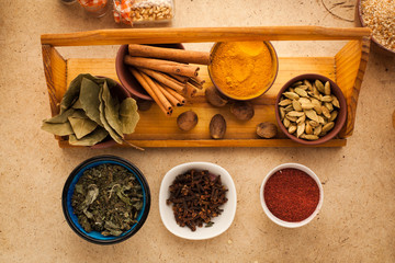 Variation of spices on wooden table in the kitchen for cooking meal. Ingredients for cooking asian food.