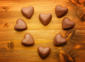 Obraz premium Chocolate hearts on wooden background