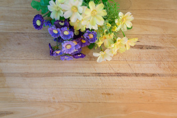 Yellow and Purple Flowers on Wooden Background 