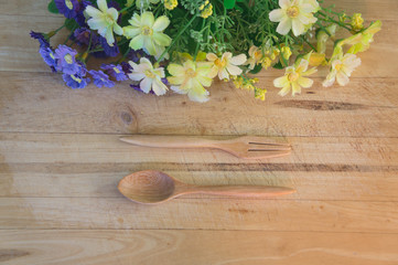 Yellow and Purple Flowers on Wooden Background 