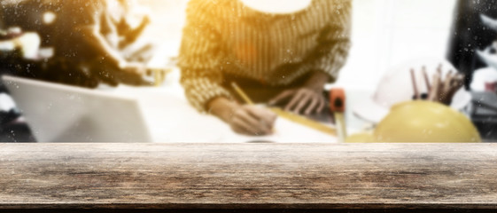 Panorama vintage wooden tabletop with blurry engineer working at