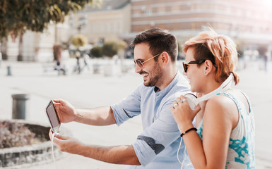 Couple listening to music with tablet and headphones