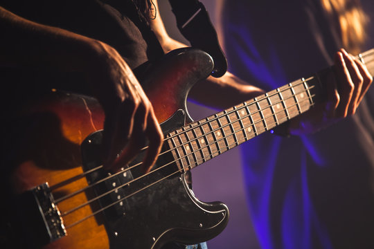 Close-up photo, bass guitar player
