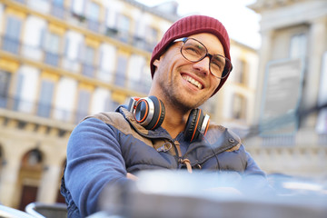 Portrait of hipster guy relaxing in town