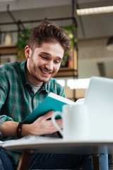 Vertical image of handsome man with book