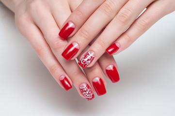 Christmas red manicure with painted Christmas toys, heart