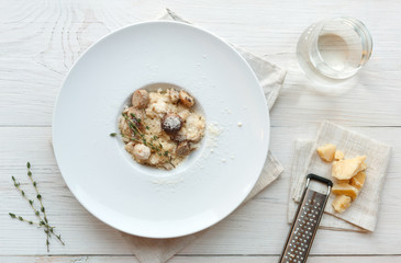 Wild mushrooms risotto with rosemary and parmesan, italian cuisine closeup