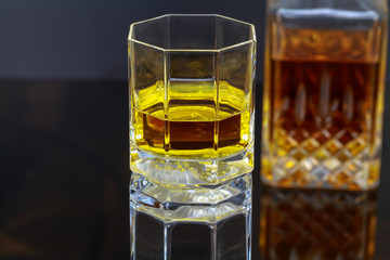 Glass with whiskey and decanter