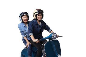 Naklejka premium Two asian woman having fun when riding the scooter