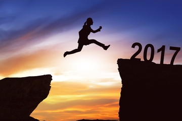 Woman jumping on the hill toward 2017