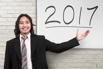 Young asian businessman showing 2017 number