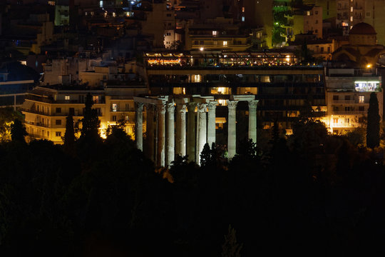 Athens Greece, night view of Olympian Zeus temple ruins and city lights