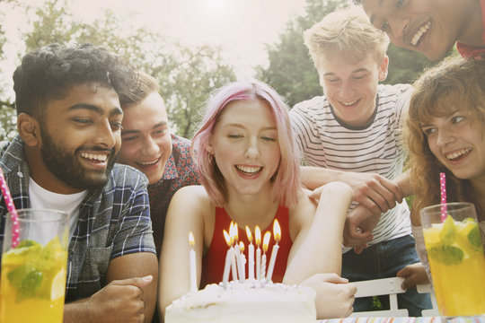 Happy friends celebrating birthday at yard